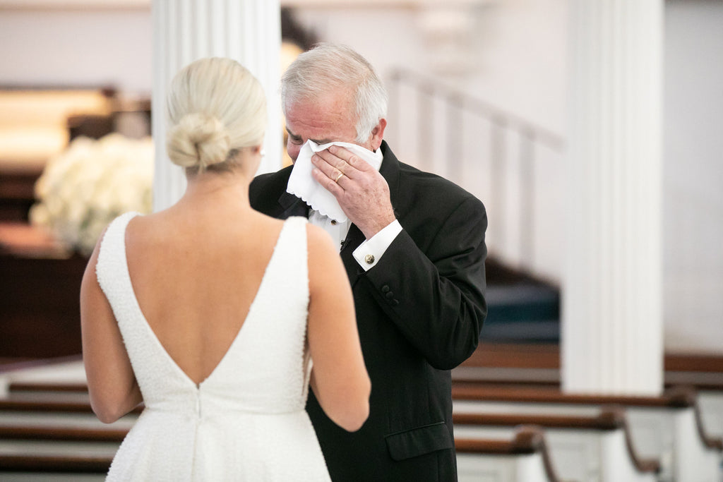 Father of the bride wiping tears with a custom handwriting handkerchief